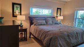 650 Golden Gate Point, Unit 301 Sarasota, FL 34236 - Photo 24 of 31 a bed sitting in a bedroom next to a window