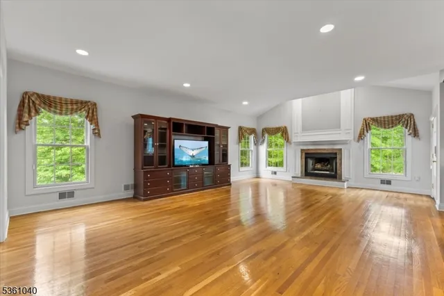 a living room with fireplace furniture and a flat screen tv