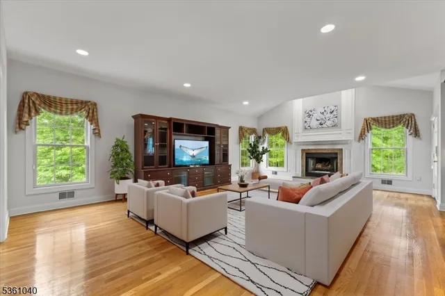 an empty room with windows and ceiling fan