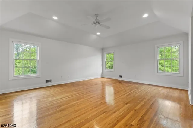 a spacious bedroom with a bed a couch and a window