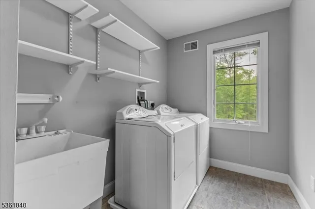 an empty room with fan and entrance