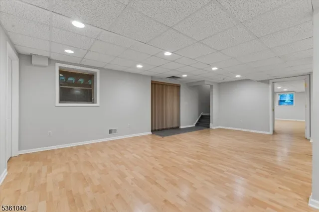 a room with furniture pool table and flat screen tv