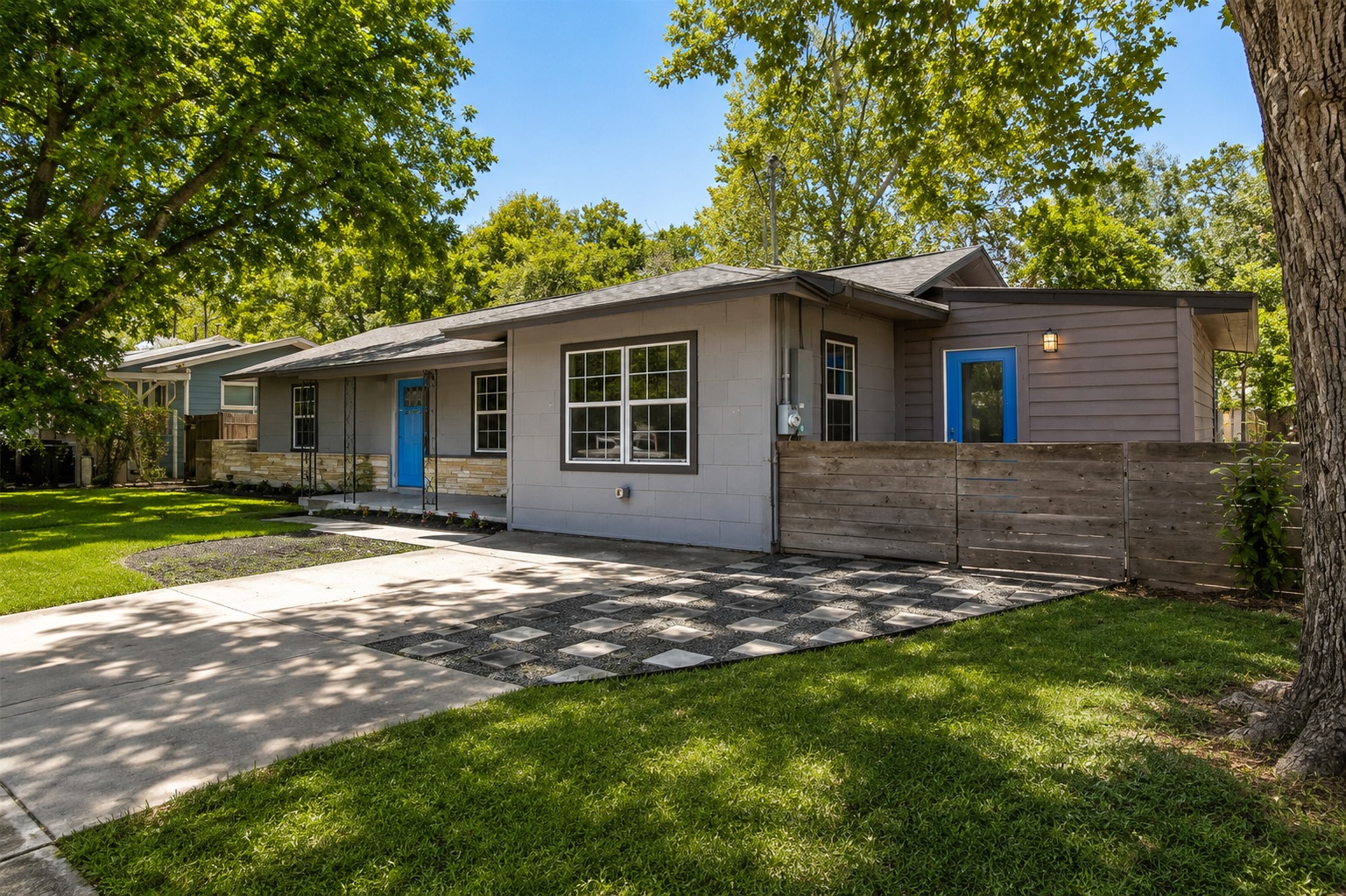 2105 Fortview Road Austin, TX 78704 - Photo 2 of 37 A welcoming front entrance featuring a bright blue door and thoughtful landscaping.