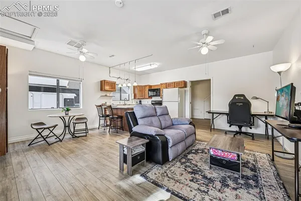 a living room with furniture and wooden floor