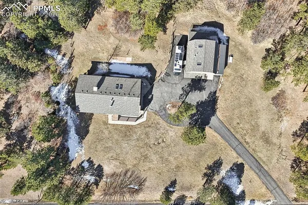an aerial view of a house with a yard