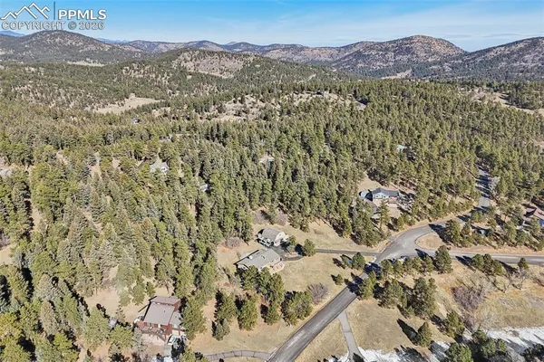 a view of a mountain range with a lush green hillside