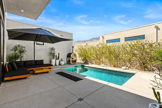 a living room with furniture and a floor to ceiling window