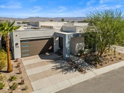 a view of a backyard with swimming pool and furniture