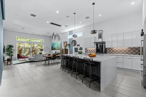 a kitchen with granite countertop a stove and a white cabinets
