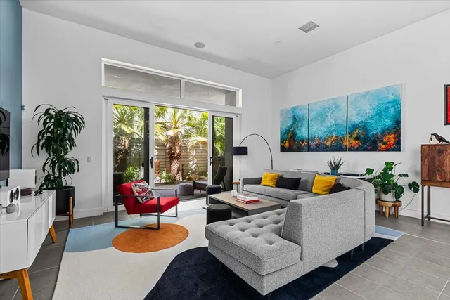 a view of a palm tree with dinning table and chair in the patio