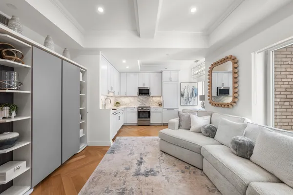 a kitchen with stainless steel appliances granite countertop a sink and a stove top oven with white cabinets