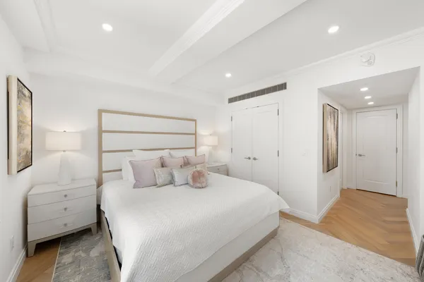 a large living room with stainless steel appliances granite countertop couches a flat screen tv and a refrigerator