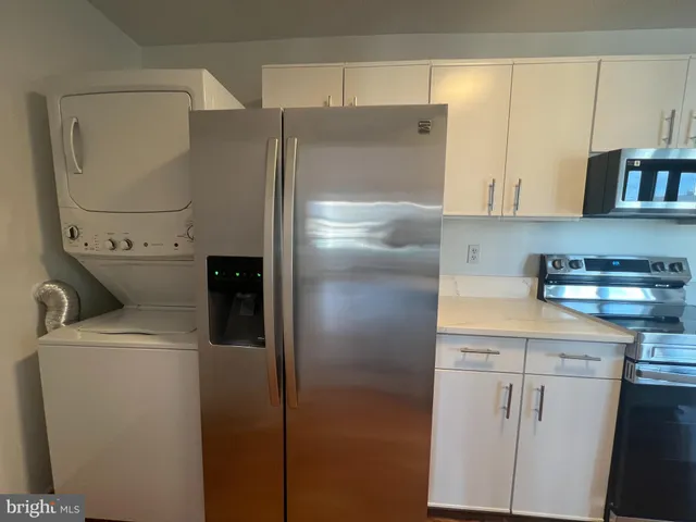 a kitchen with stainless steel appliances a refrigerator and a sink