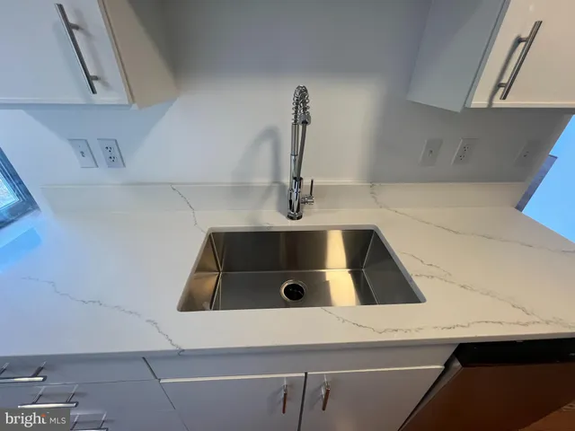 a kitchen with a sink and a refrigerator