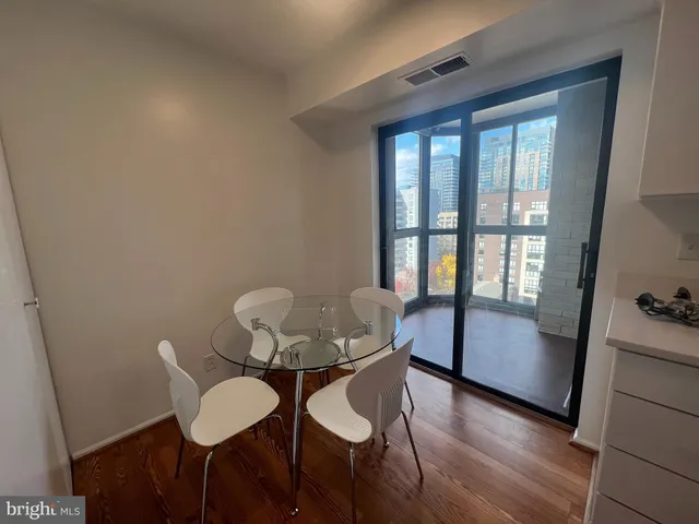 a view of a room with furniture and wooden floor
