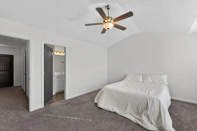 a bedroom with a bed and a ceiling fan
