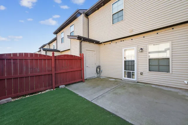 a view of backyard with small cabin and wooden fencing