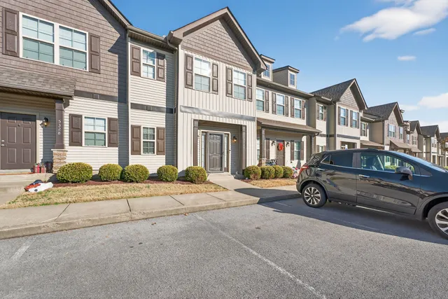 a car parked in front of a brick house