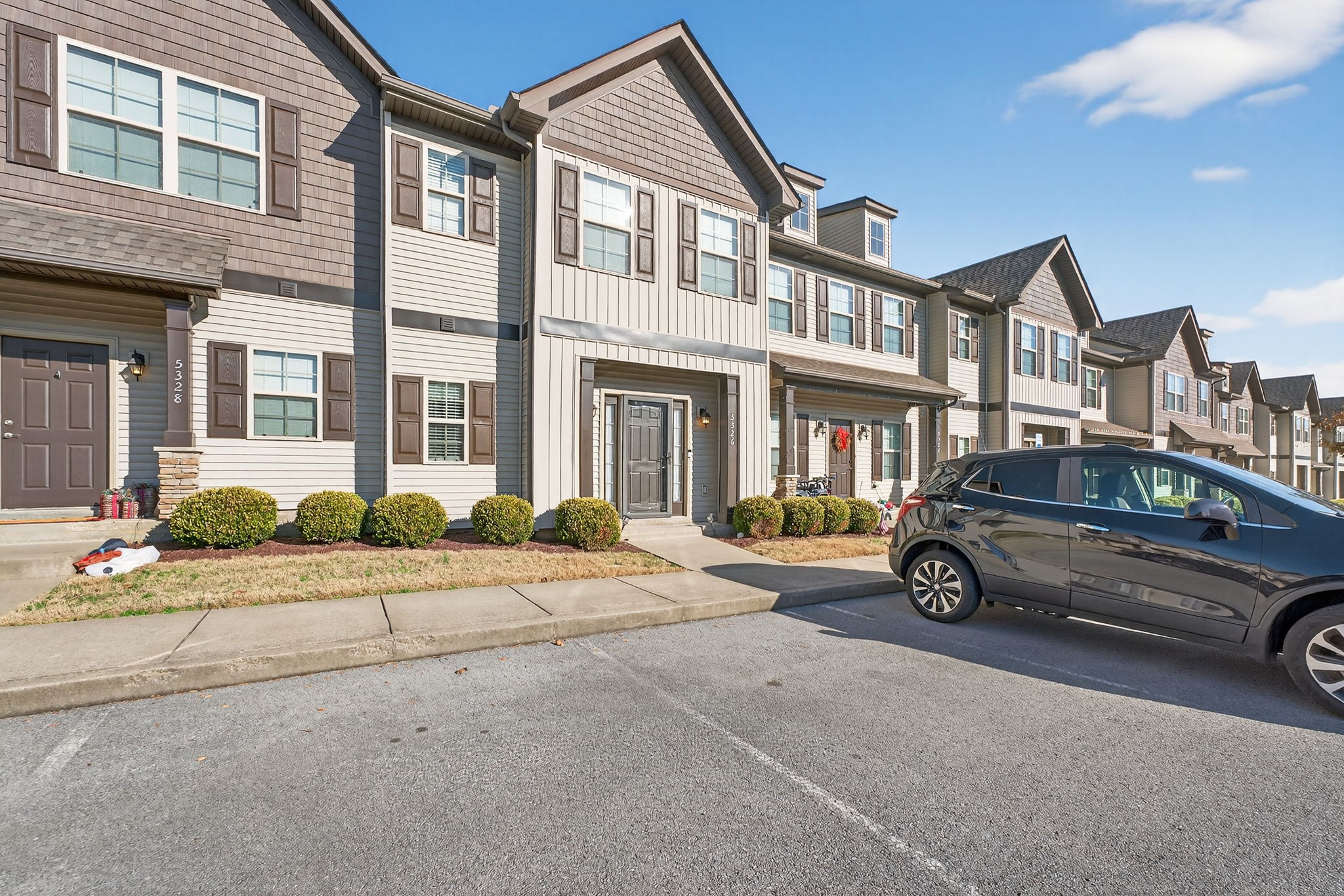 5326 Dan Post Way Murfreesboro, TN 37128 - Photo 2 of 17 a car parked in front of a brick house