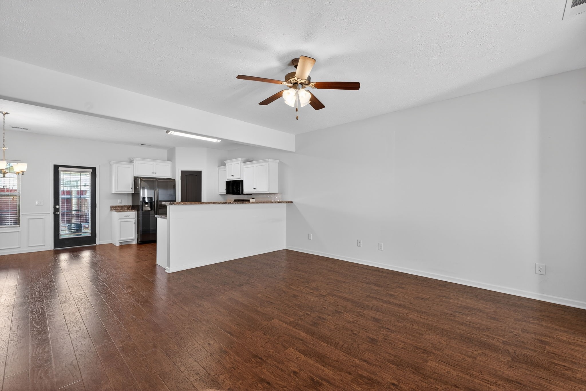 5326 Dan Post Way Murfreesboro, TN 37128 - Photo 4 of 17 a view of a kitchen with wooden floor and a ceiling fan