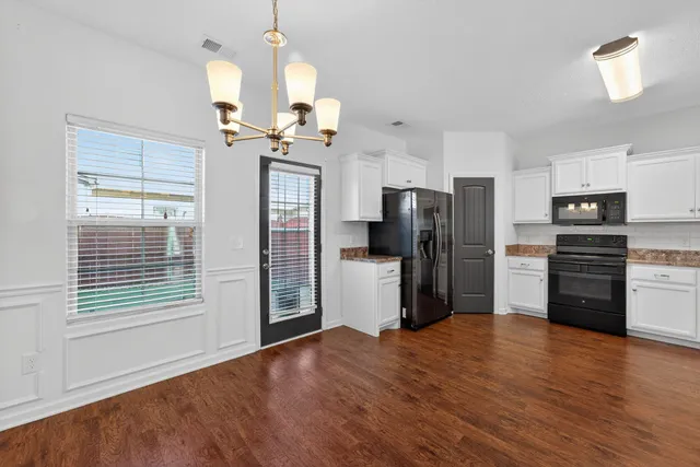a kitchen with stainless steel appliances a refrigerator and a stove top oven
