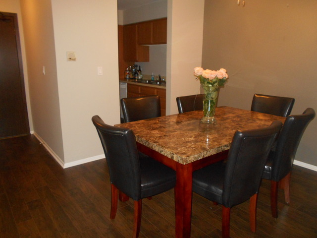 6160 Knoll Wood Road, Unit 206 Willowbrook, IL 60527 - Photo 12 of 17 a dining table with chairs and wooden floor