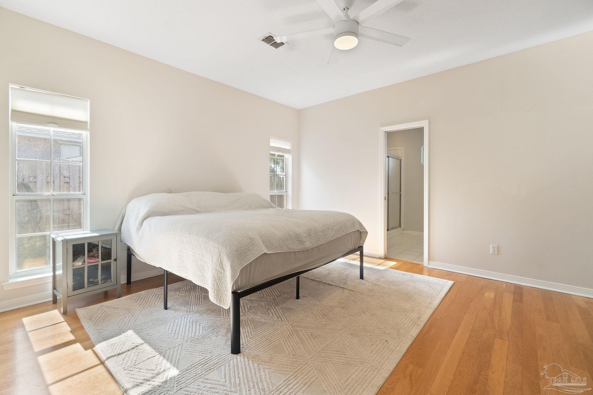 1504 Muirfield Road Cantonment, FL 32533 - Photo 18 of 35 a bedroom with a bed and a table in it