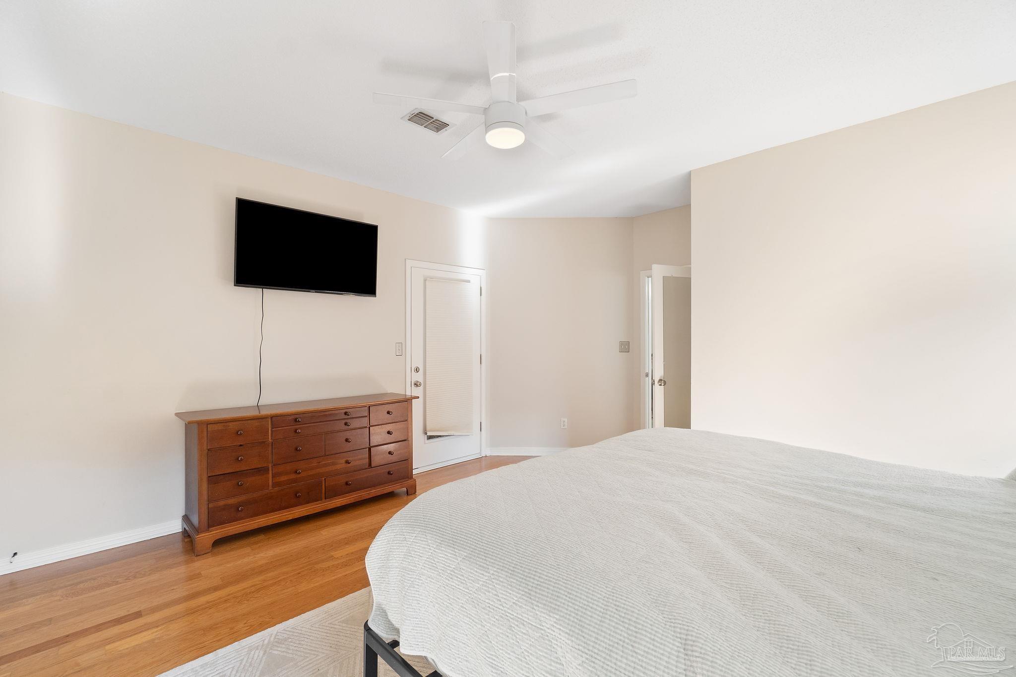 1504 Muirfield Road Cantonment, FL 32533 - Photo 21 of 35 a bedroom with a bed and a flat screen tv