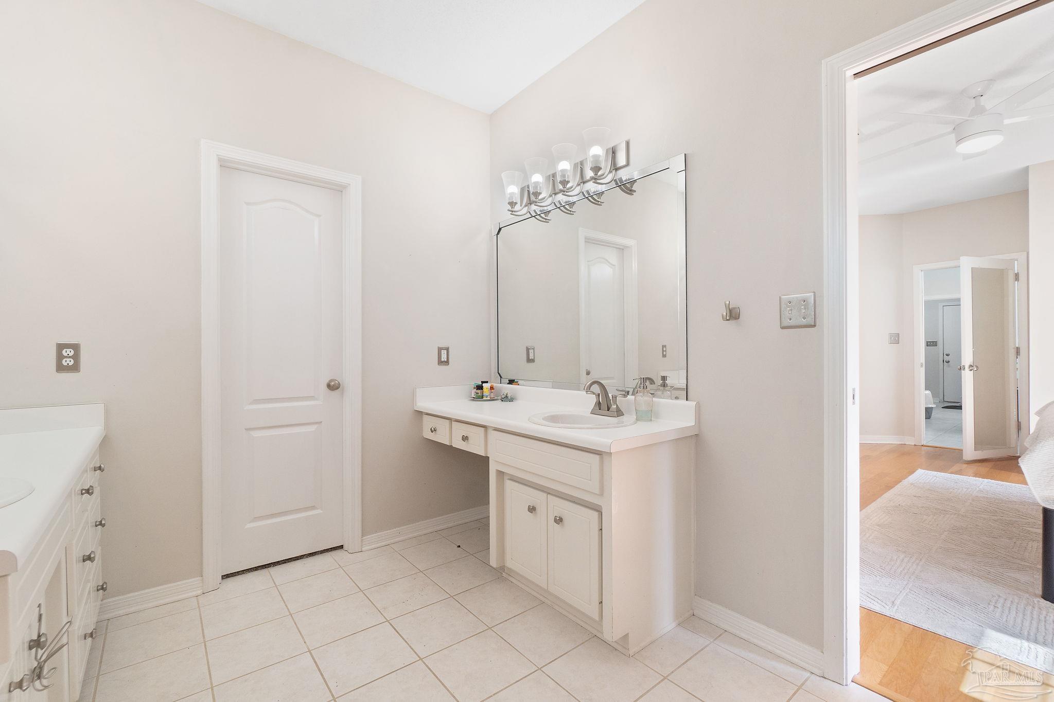 1504 Muirfield Road Cantonment, FL 32533 - Photo 23 of 35 a spacious bathroom with a double vanity sink and a mirror