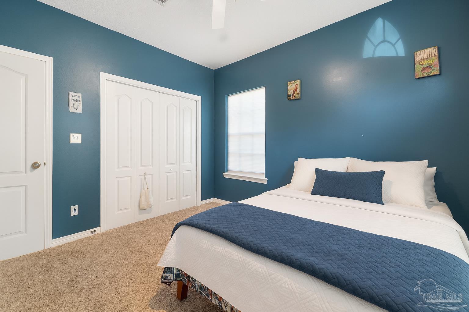 1504 Muirfield Road Cantonment, FL 32533 - Photo 27 of 35 a bedroom with a bed and a window