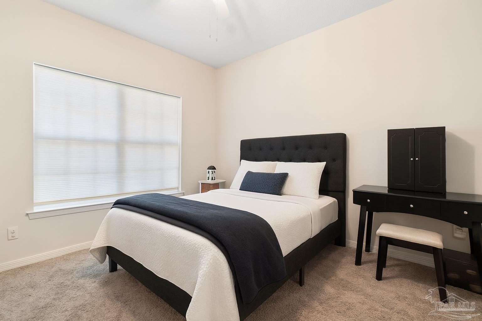 1504 Muirfield Road Cantonment, FL 32533 - Photo 28 of 35 a bedroom with a bed and a window