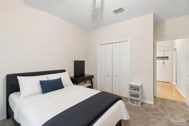 a bedroom with a bed and a television