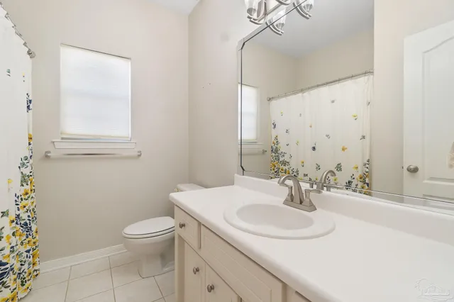 a bathroom with a sink toilet and a mirror