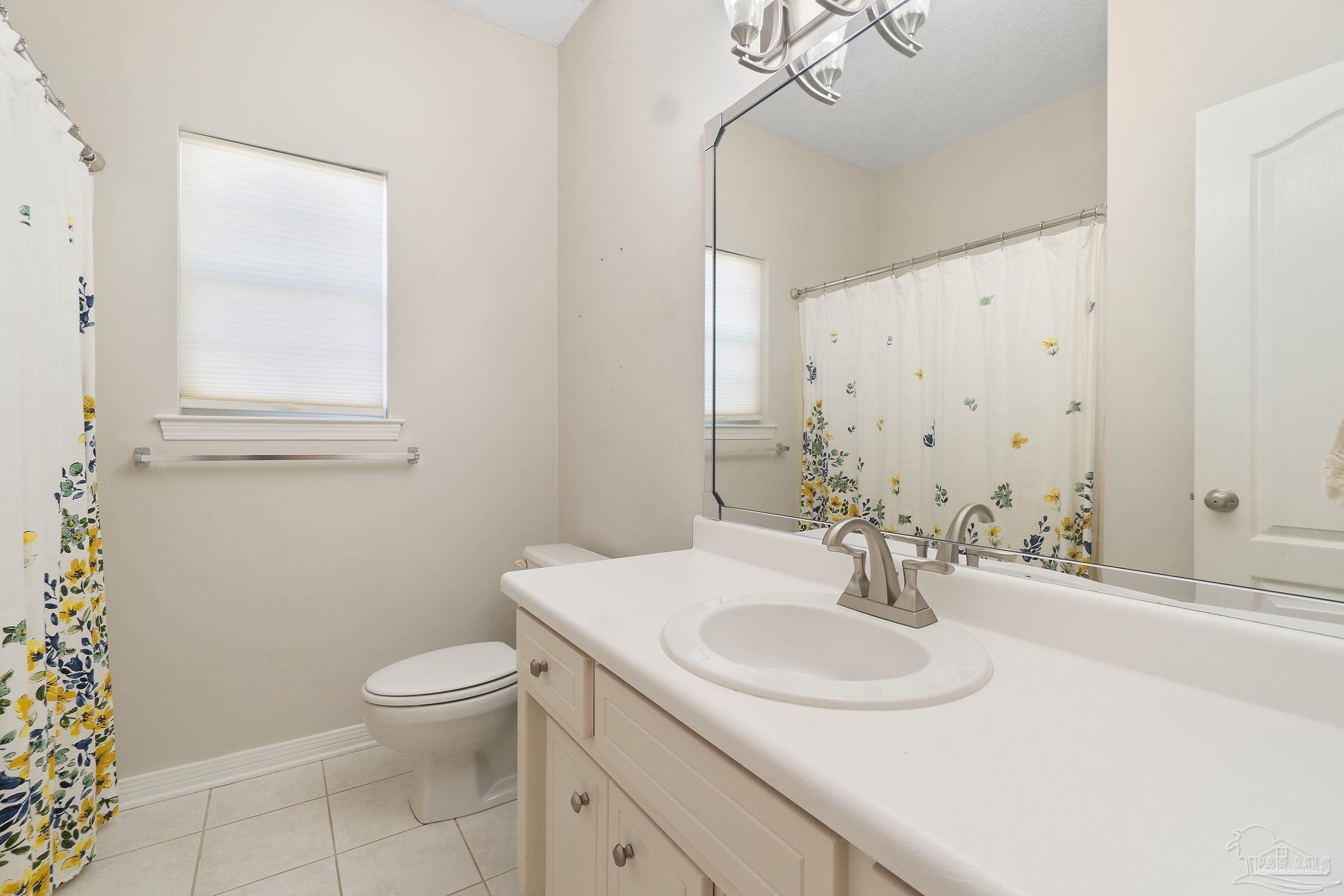 1504 Muirfield Road Cantonment, FL 32533 - Photo 31 of 35 a bathroom with a sink toilet and a mirror