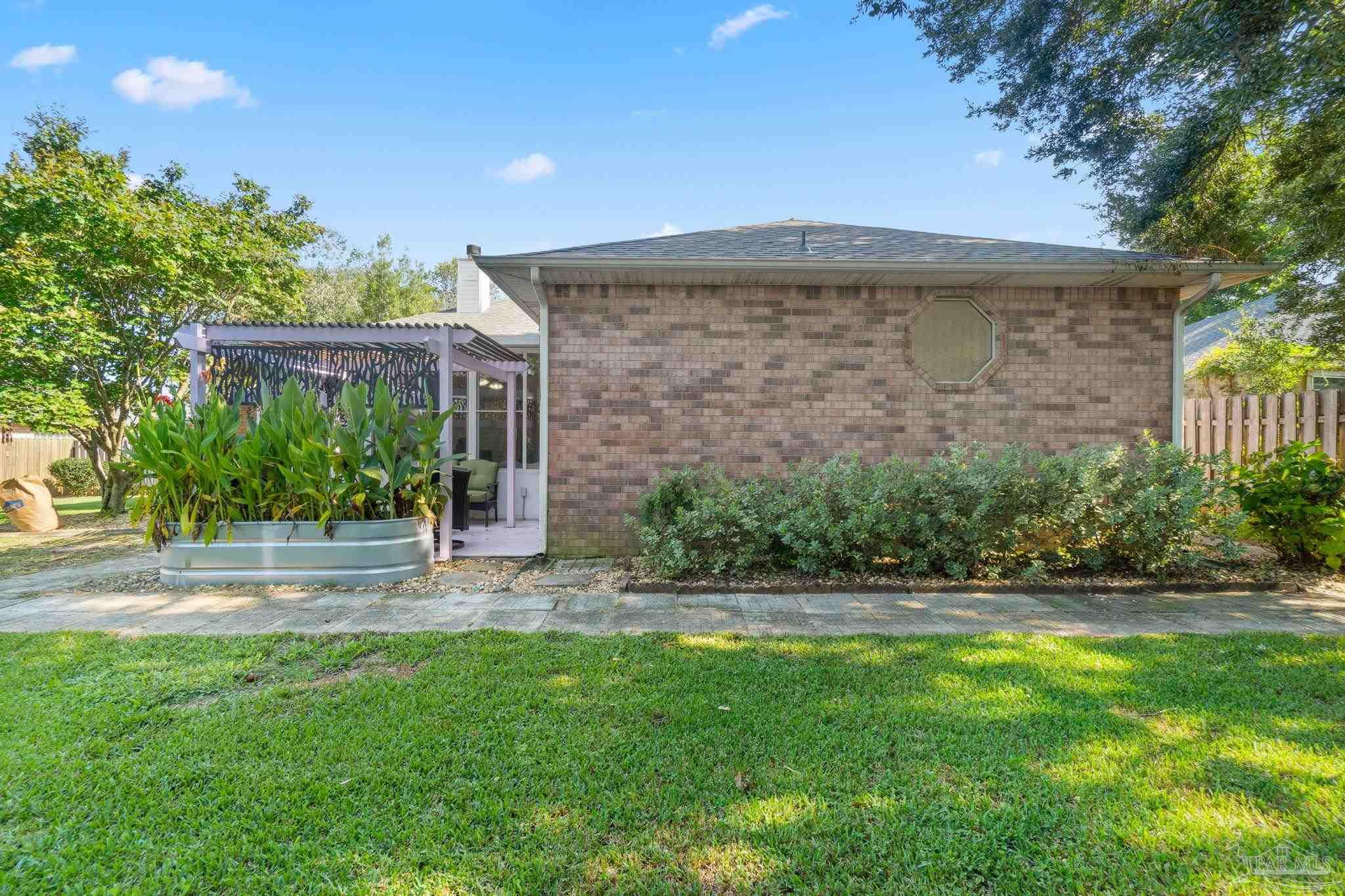 1504 Muirfield Road Cantonment, FL 32533 - Photo 34 of 35 a front view of a house with a yard