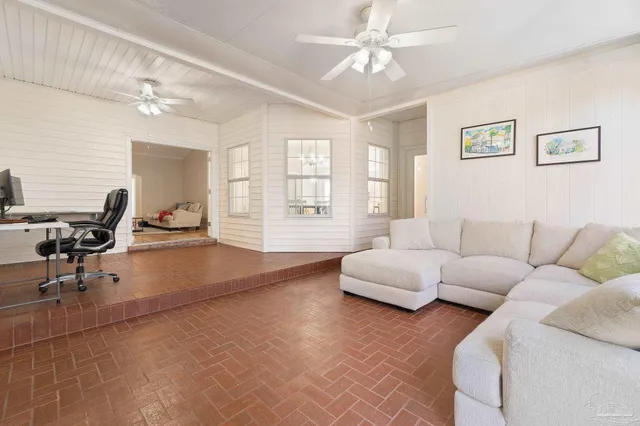 a living room with furniture and white walls