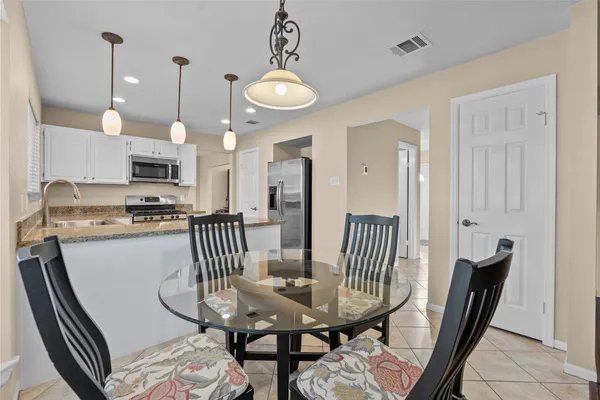 a view of a dining room with furniture wooden floor and chandelier