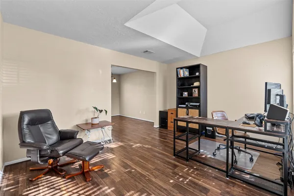 a view of a workspace with furniture and window