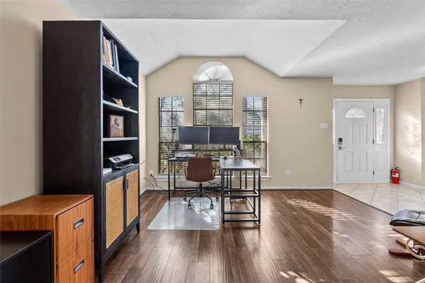 a view of a dining room with furniture wooden floor and a chandelier
