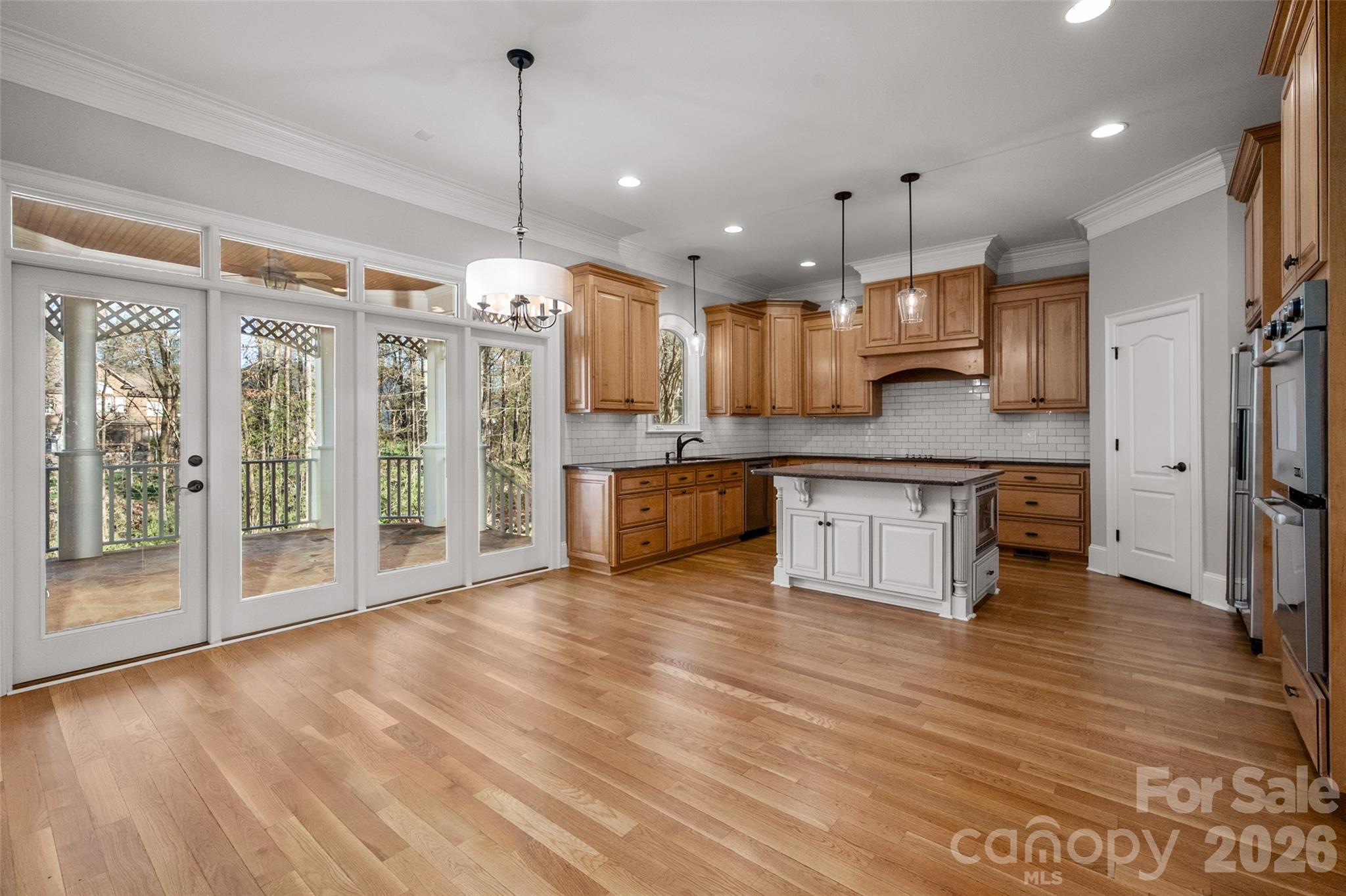 406 Belo Court Fort Mill, SC 29715 - Photo 18 of 46 a large kitchen with stainless steel appliances granite countertop a refrigerator a oven and a wooden floors