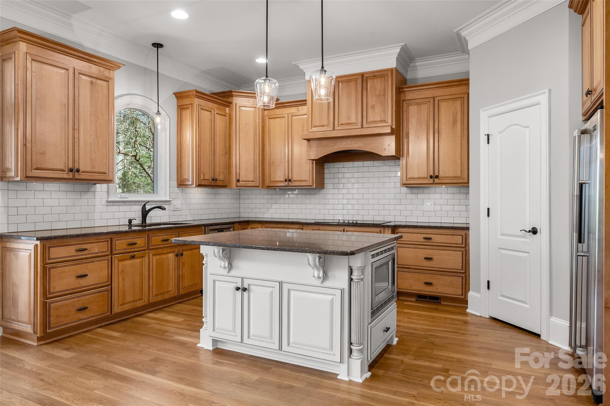 406 Belo Court Fort Mill, SC 29715 - Photo 19 of 46 a kitchen with stainless steel appliances granite countertop a sink a stove and a wooden cabinets