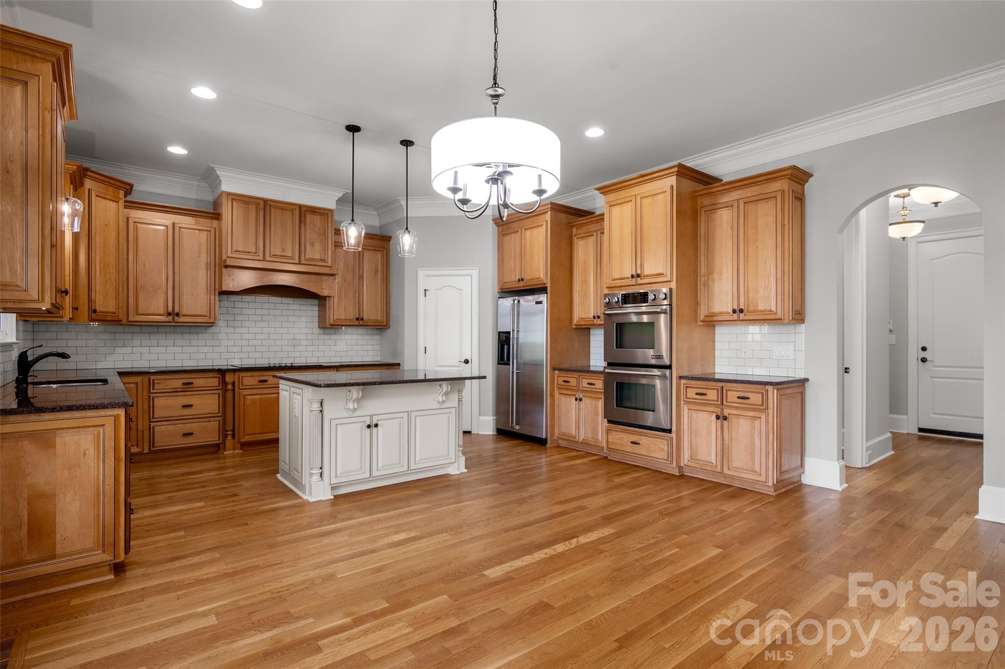 406 Belo Court Fort Mill, SC 29715 - Photo 20 of 46 a large kitchen with stainless steel appliances granite countertop a stove a sink and a refrigerator