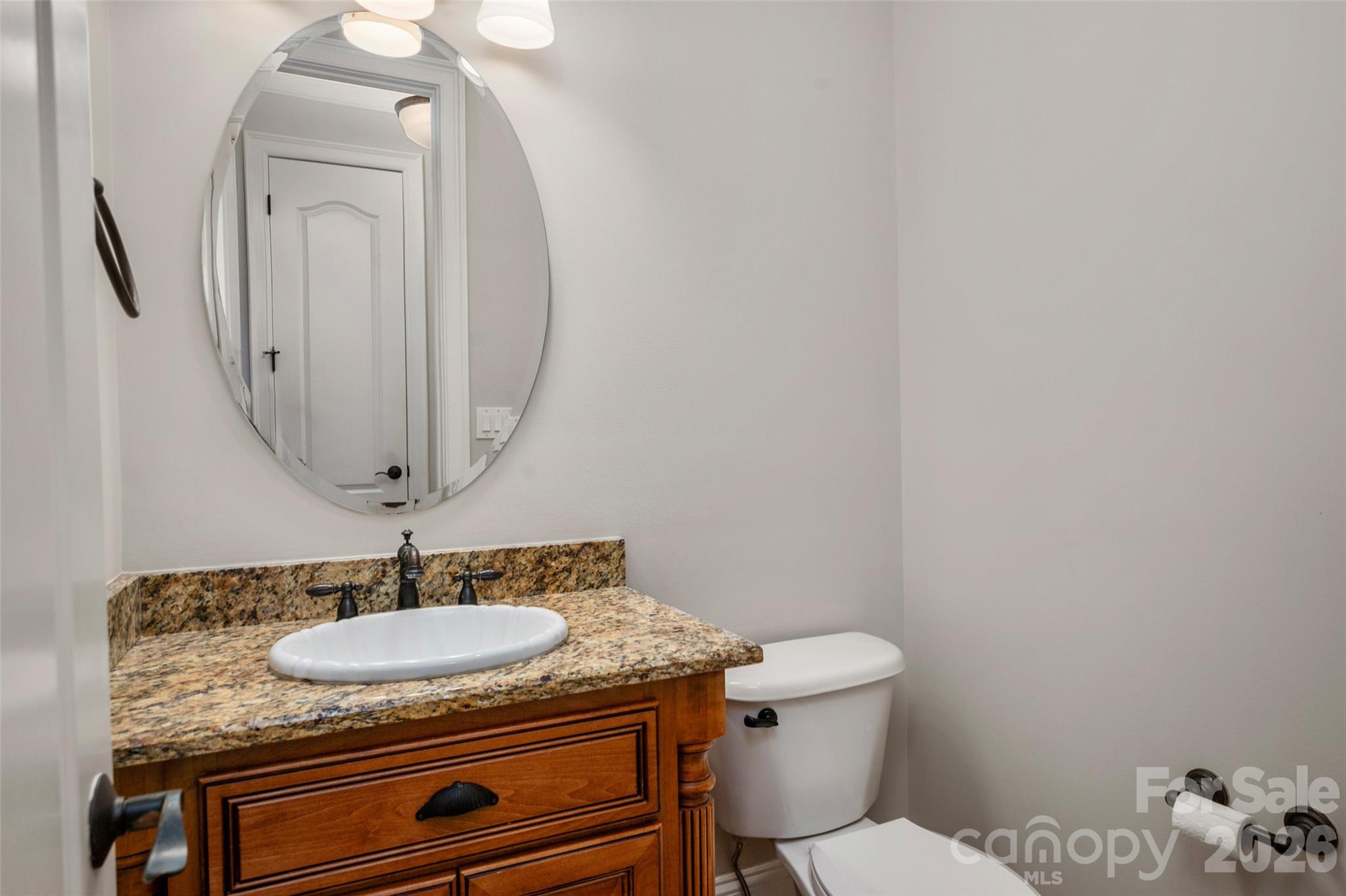 406 Belo Court Fort Mill, SC 29715 - Photo 25 of 46 a bathroom with a granite countertop sink a toilet and a mirror