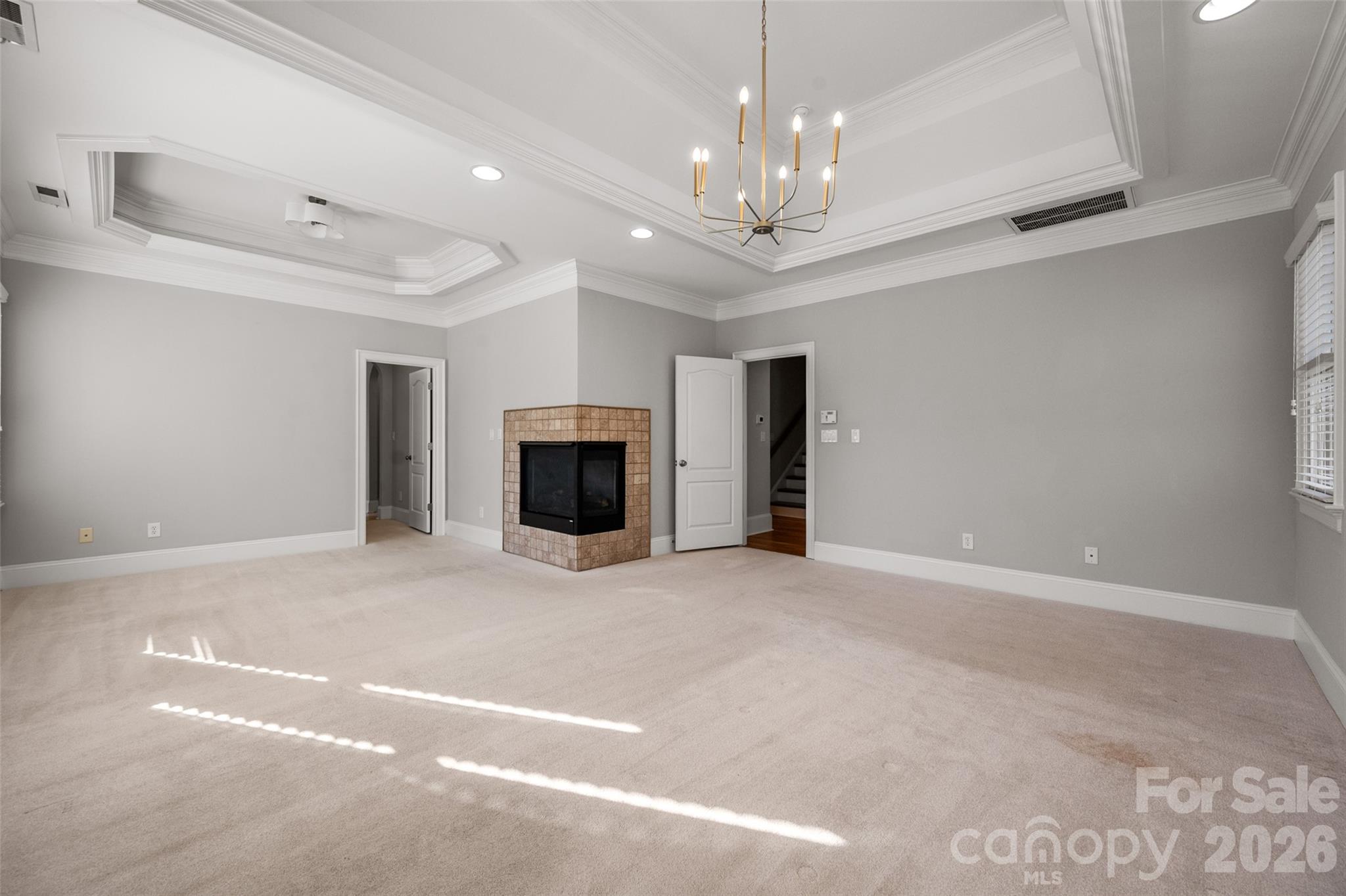 406 Belo Court Fort Mill, SC 29715 - Photo 29 of 46 a view of empty room with a fireplace and chandelier