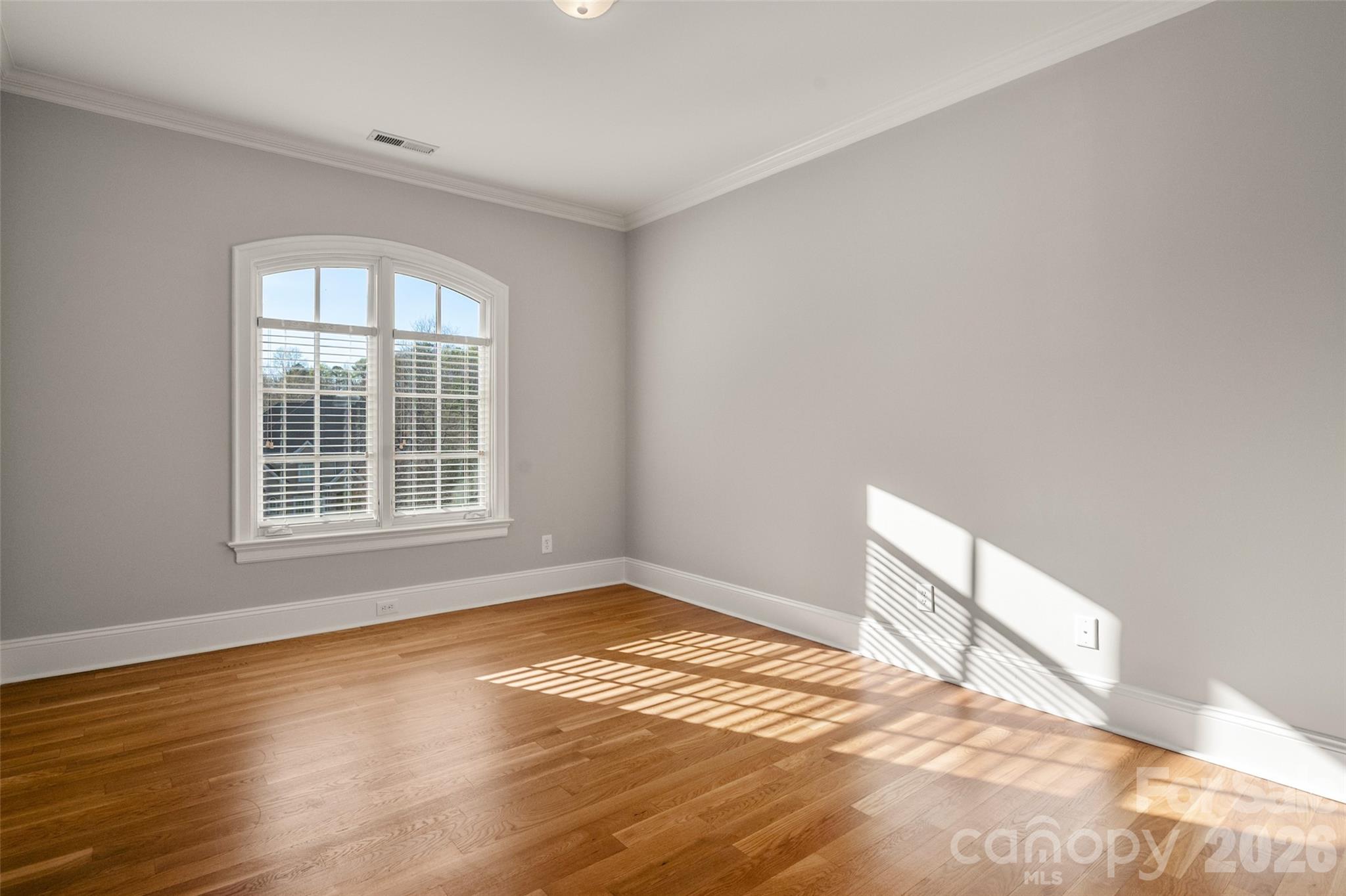 406 Belo Court Fort Mill, SC 29715 - Photo 34 of 46 a view of an empty room with wooden floor and a window