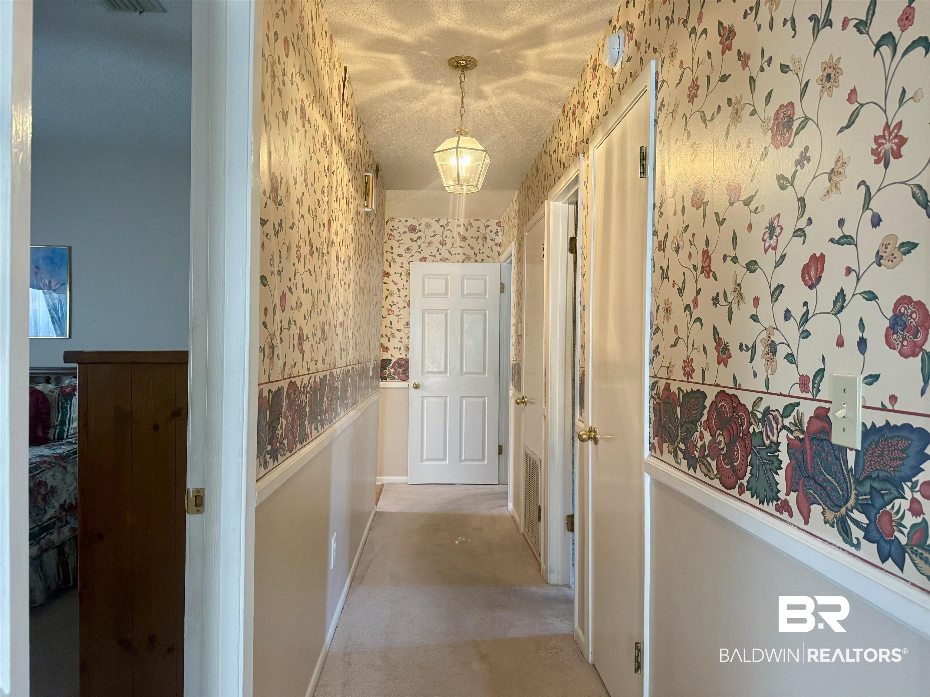 215 Young Street Brewton, AL 36426 - Photo 15 of 25 Hall featuring wallpapered walls, light colored carpet, and a wainscoted wall