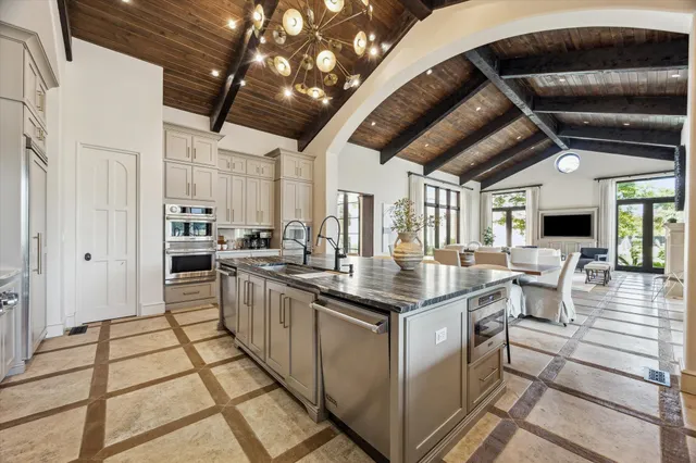 a work room with furniture and large windows