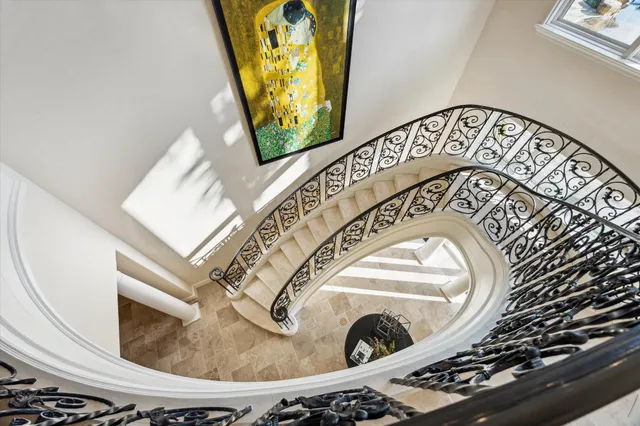 a bedroom with a large bed and a flat tv screen on dresser