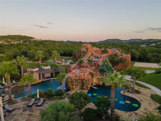 a view of a room with gym equipment and a chandelier