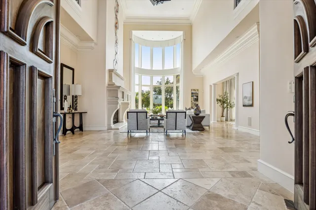 a very nice looking living room with a large window and a chandelier